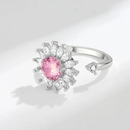 Silver ring with a pink gemstone on a light gray background